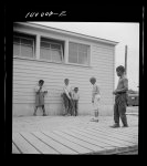 [Untitled photo, possibly related to: Arlington, Virginia. FSA (Farm Security Administration) trailer camp project for Negroes. Children playing marbles outside the community building]