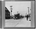 Detroit, Michigan. Riot at the Sojourner Truth homes, a new U.S. federal housing project, caused by white neighbors' attempt to prevent Negro tenants from moving in. Moving vans convoyed by police department moving Negroes' furniture into Sojourner Truth