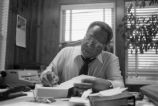 Alex Haley: Seated at desk (AHP 1-79-11 #63)