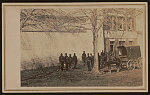 [Unidentified soldiers in Union uniforms standing with a horse and buggy at site of former slave pen, with sign reading "Price, Birch &amp; Co., Dealers in Slaves"]