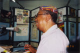 Eugene Redmond seated at a microphone