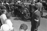 Pallbearers, including T. Y. Rogers, James Bevel, James Orange, and Jesse Jackson, waiting to roll Martin Luther King, Jr.'s casket down the street.