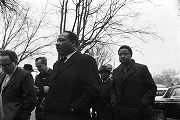 Martin Luther King, Jr., Hosea Williams, and other men, walking through a parking lot toward Tabernacle Baptist Church in Selma, Alabama.