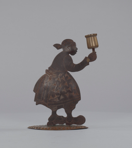 Candleholder in the form of a silhouette of a caricatured woman