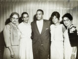 Five people posing for a group photograph