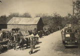 Mules and wagons lined up along the road at the Turkey Carnival in Uniontown, Alabama.