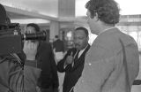 Martin Luther King, Jr., being interviewed at the airport in Montgomery, Alabama.