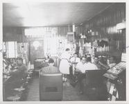 Mississippi State Sovereignty Commission photograph of the interior of Stanley's Cafe showing a waitress and men eating while seated at tables, booths and counter, Winona, Mississippi, 1961 November 1