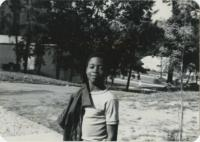 Young Adult Posing Outside with Jacket over Shoulder