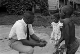 Wanzo Hendrix talking to a boy and a girl.