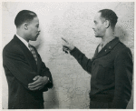 Major Steve G. Davis, General Staff Corps, points to areas that will be visited by Mr. Marcus to areas that will be visited by Mr. Marcus H. Ray [left], Civilian Aide to Secretary of War, on his tour of Army installations in the European and Mediterranean Theaters where Negro troops are stationed