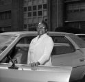 Midwife Onnie Lee Logan standing at her car outside the Mobile County Board of Health on Cox Street in Mobile, Alabama.