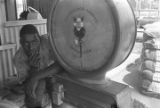 Young man beside a large scale at a cotton gin near Mount Meigs in Montgomery County, Alabama.