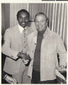 Photograph of Roosevelt Toston shaking hands with country music star Eddie Arnold, circa 1973