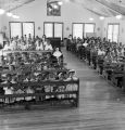 Children and nuns kneeling in pews in the chapel at Nazareth Catholic Mission in Montgomery, Alabama.