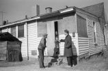 Pat Thomas talking with elderly man and woman.