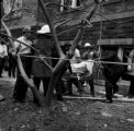 Thumbnail for Men carrying one of the victims of the 16th Street Baptist Church bombing away from the building on a stretcher.