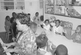 Woman playing the piano while children sing at the Children's Hope Center at 487 South Jackson Street in Montgomery, Alabama.