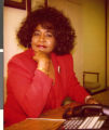 Series of three Polaroid photographs of Marzette Lewis at her desk