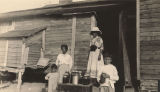 Thumbnail for African American women and children with jars of preserves in front of a cabin in Madison County, Alabama.