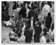 Mississippi State Sovereignty Commission photograph of Jo Freeman, Dolly Franklin, Duran Bell and Bernardo Garcia standing around a table distributing information during a college student demonstration, Berkeley, California, 1964 December