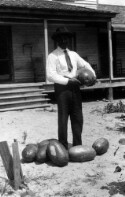 Bettis Academy? Unidentified man holding watermelon and surrounded by watermelons