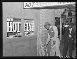 Chitterlings, fish and sugarcane on street in Negro section, Clarksdale, Mississippi Delta, on a Saturday afternoon