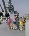 Thumbnail for Children standing around an anti-aircraft gun on the deck of the USS Alabama in Mobile, Alabama.