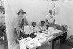 Black Agenda Business Fair organizers posing at their booth, Los Angeles, 1986