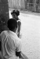 Young man and woman standing in front of Pugh's Superette on Foster Street in Newtown, a neighborhood in Montgomery, Alabama.