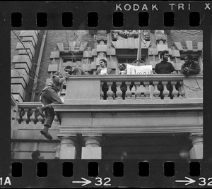 Student climbs up Boston University administration building during sit-in