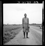 Negro woman carrying her shoes home from church. Mississippi Delta