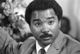 Norman Lumpkin, news director for WRMA radio, holding a microphone while Martin Luther King, Jr., speaks to a crowd at Maggie Street Baptist Church in Montgomery, Alabama.