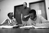 An advisor talks with two students during a study session, 1993