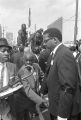 T. Y. Rogers and Jesse Jackson on the cart carrying Martin Luther King, Jr.'s casket during the funeral procession on Auburn Avenue.