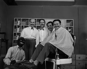 Five men on barbershop set, one in blackface