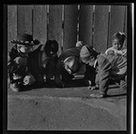 Group of children drawing on the ground, California Labor School