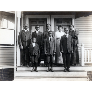 Family portrait, eight family members pose on steps