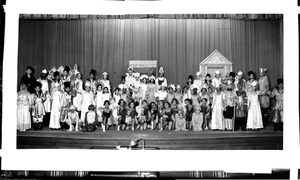 Children in a play, group on stage in costumes including boys dressed in frog costumes : acetate film photonegative