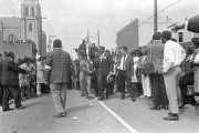 T. Y. Rogers and Jesse Jackson on the cart carrying Martin Luther King, Jr.'s casket during the funeral procession on Auburn Avenue.