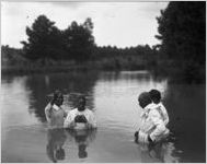 African American woman is baptized.