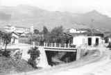 Colombia, bridge over stream in eastern Medellín