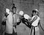 African American couple enjoying the carnival at Neighborhood House, 825 Yesler Way, Seattle, May 14, 1954