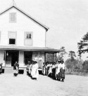 Unidentified women and building. Colored