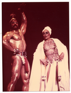 Performance picture of Eartha Kitt (in white turban) and a man]. [color photoprint