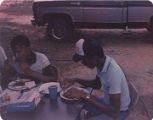 Members of the American Agriculture Movement eating barbecue at a gathering on Oscar Belvin’s farm in Montezuma, Georgia.