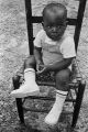 Michael Dabney seated on a chair during a cookout in the Madison Park community in Montgomery, Alabama.