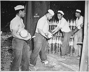 Thumbnail for "Enlisted men serving on Espiritu Santo in the New Hebrides...placing 6-inch shells in magazines at the Naval Ammunition Depot."