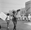 Civil rights activists Rachel Nelson and Sheyann Webb demonstrating at a Ku Klux Klan march on Broad Street in Selma, Alabama.