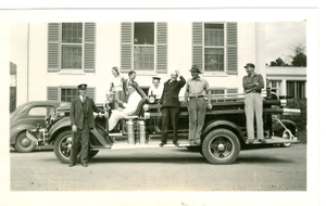 Photograph of a group of staff members standing on top of a new 1939 Ford firetruck at the Georgia Warm Springs Foundation, Warm Springs, Meriwether County, Georgia, sometime between 1939-1940?